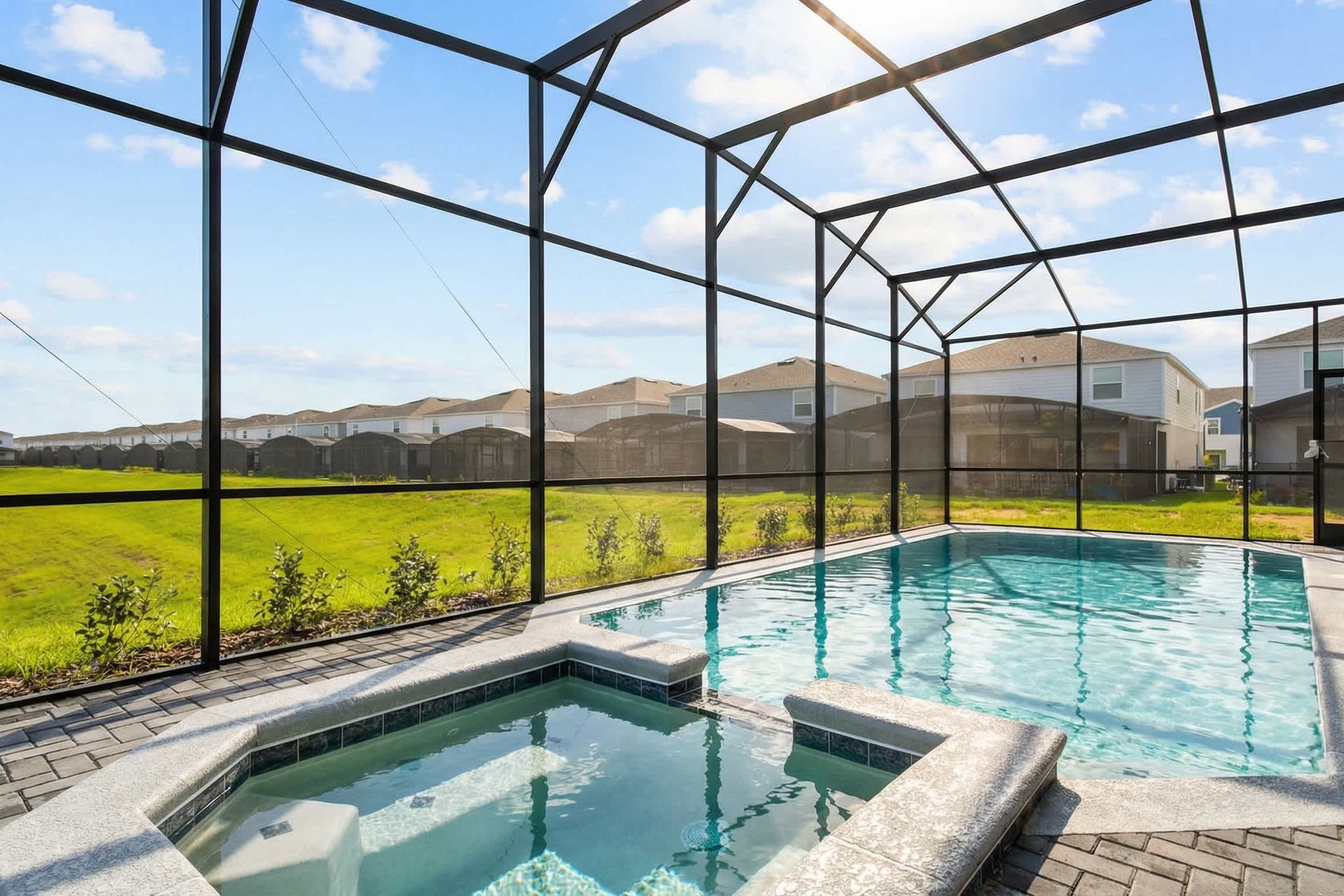 Private screened-in pool and spa with peaceful green views—pure relaxation.