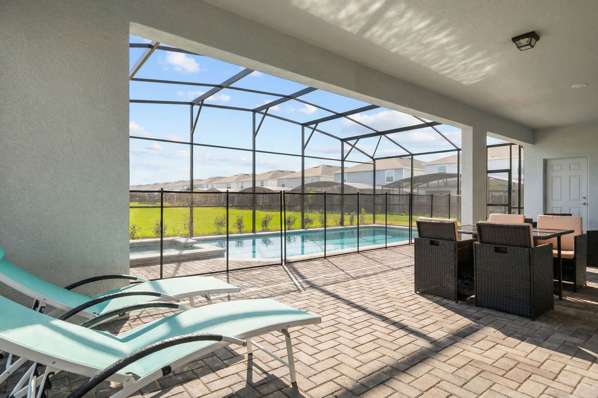 Relax in the shaded lanai with pool views and comfy lounge seating.