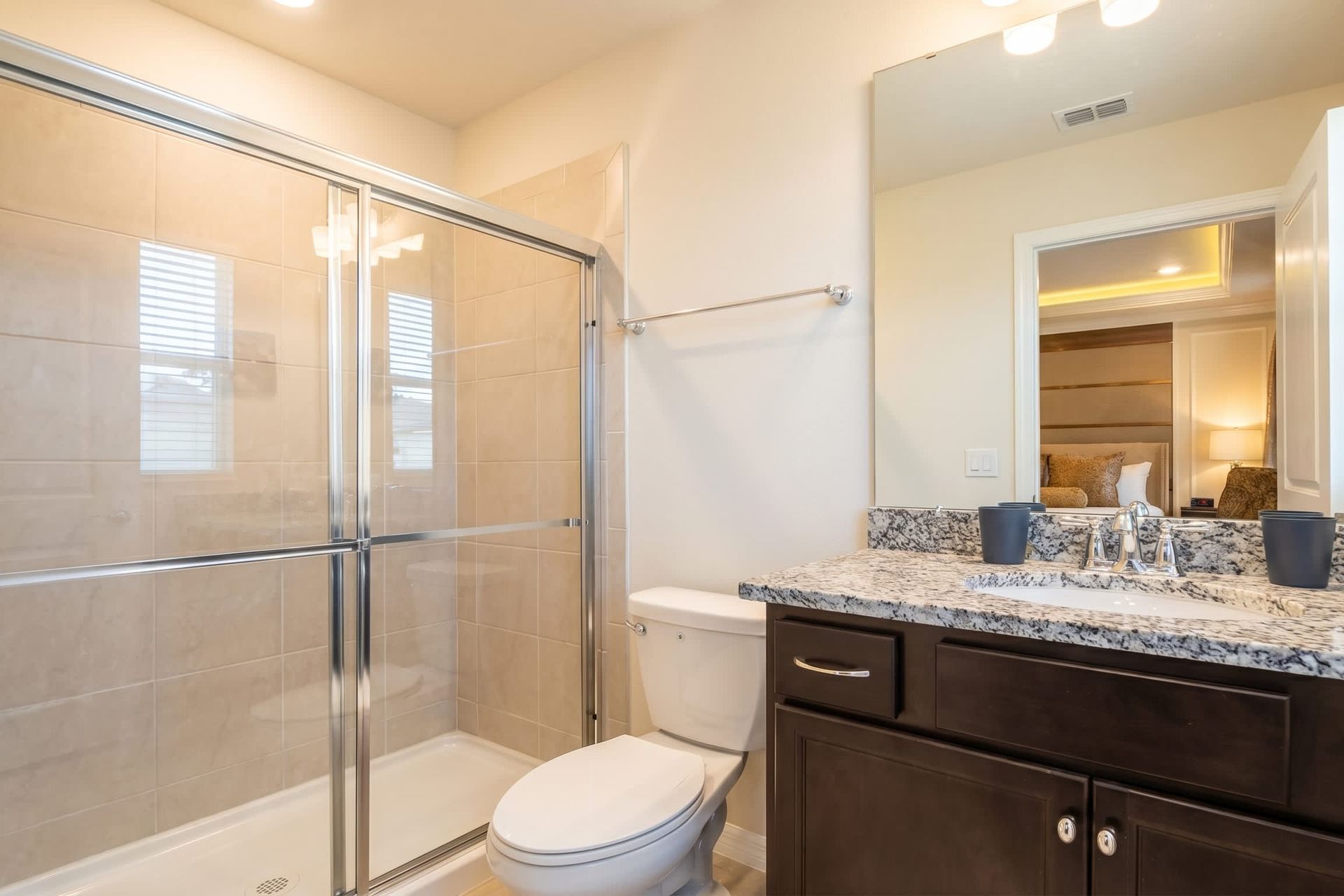 Elegant full bath with granite vanity and direct access to the Harry Potter room.