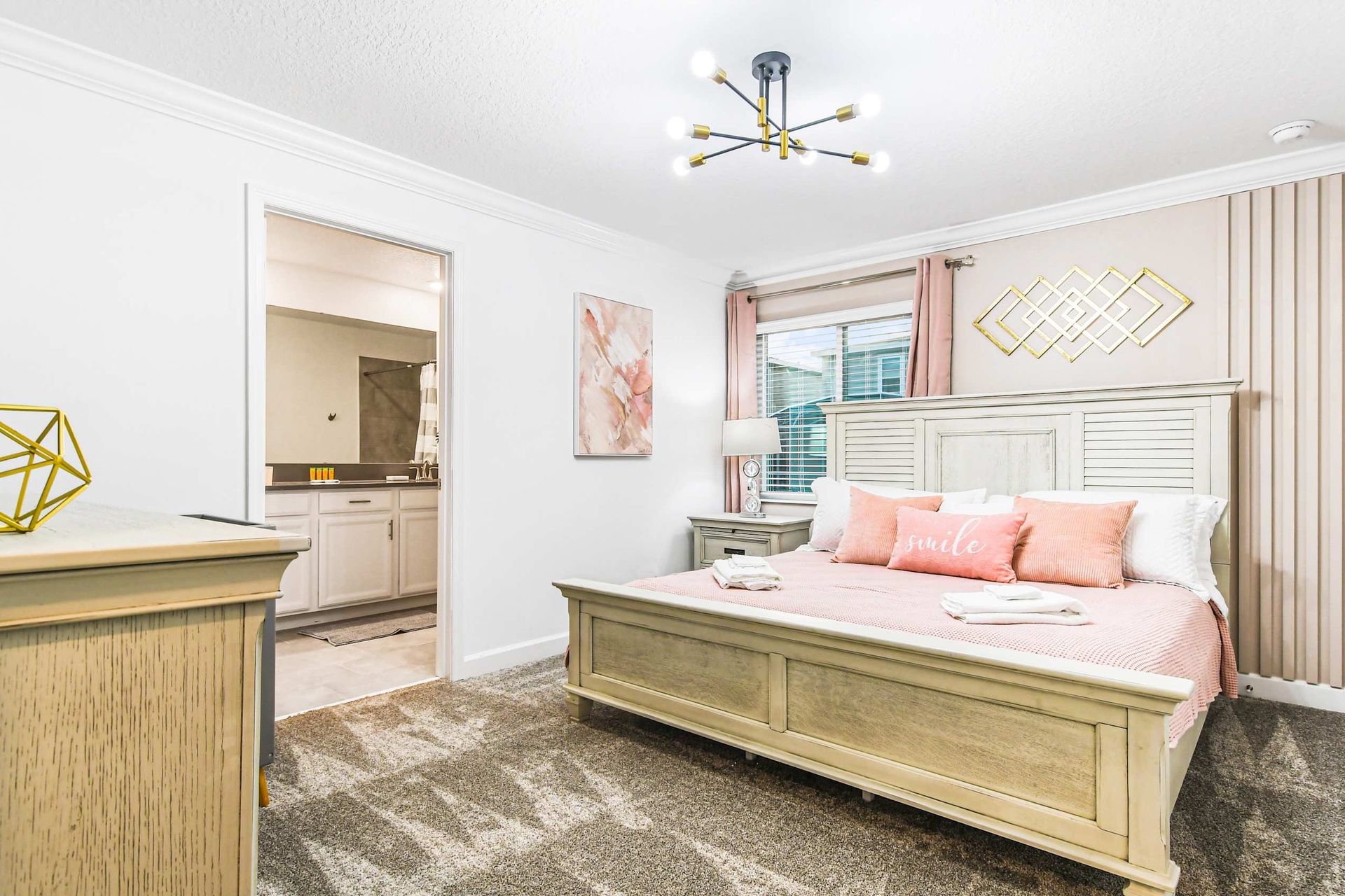 Opulent master bedroom boasts a spacious king bed, complemented by a crib for added comfort