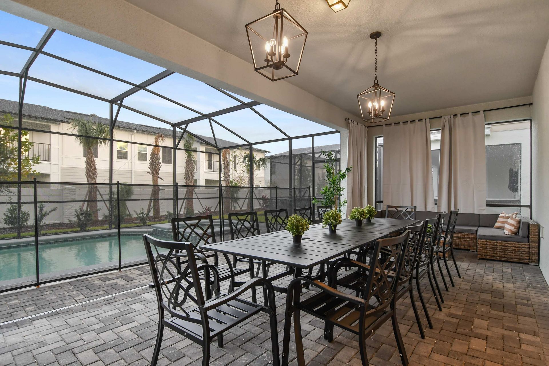Covered patio with pool views—ideal for dining and lounging!