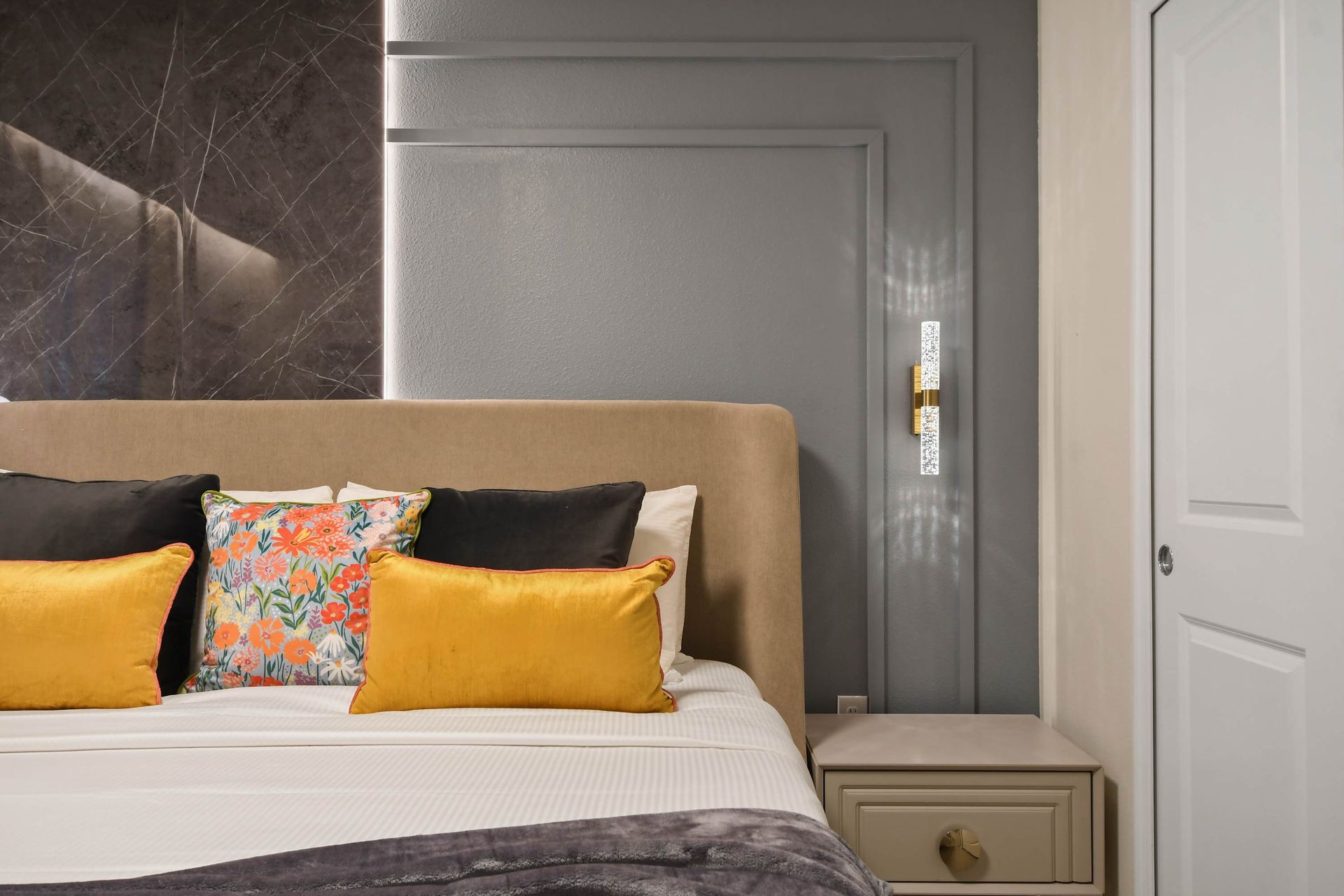 Elegant bedroom with modern lighting, soft tones, and cozy decor.