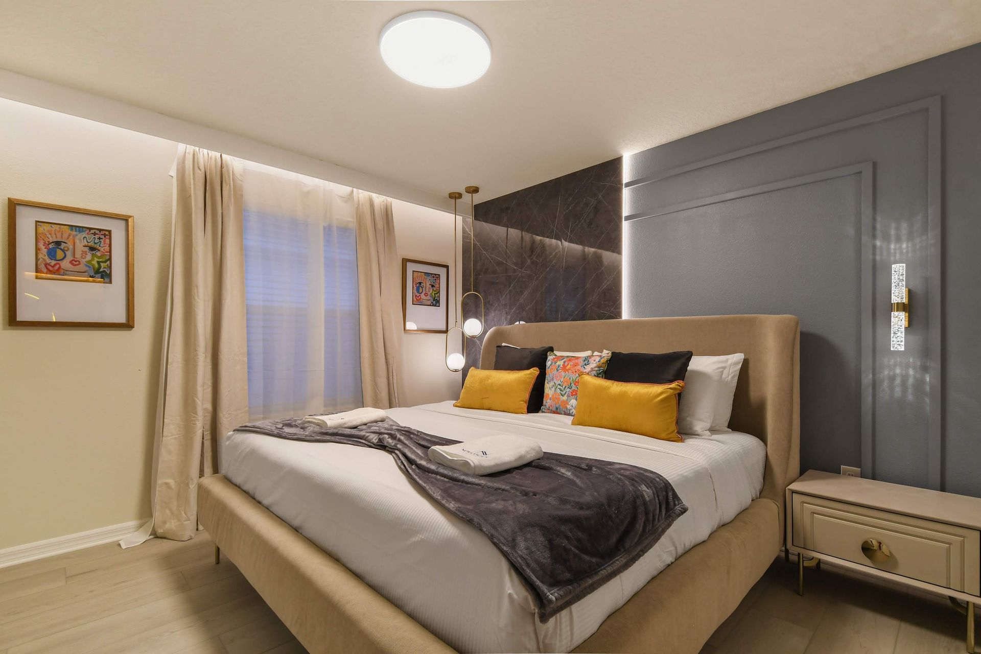 Chic bedroom with modern accents, cozy king bed, and soft lighting.