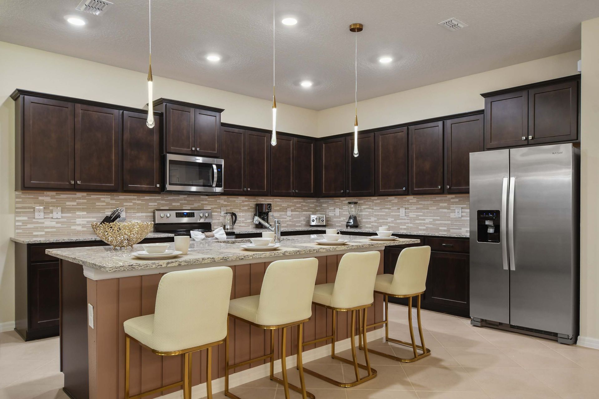 Modern kitchen with sleek appliances, island seating, and style.