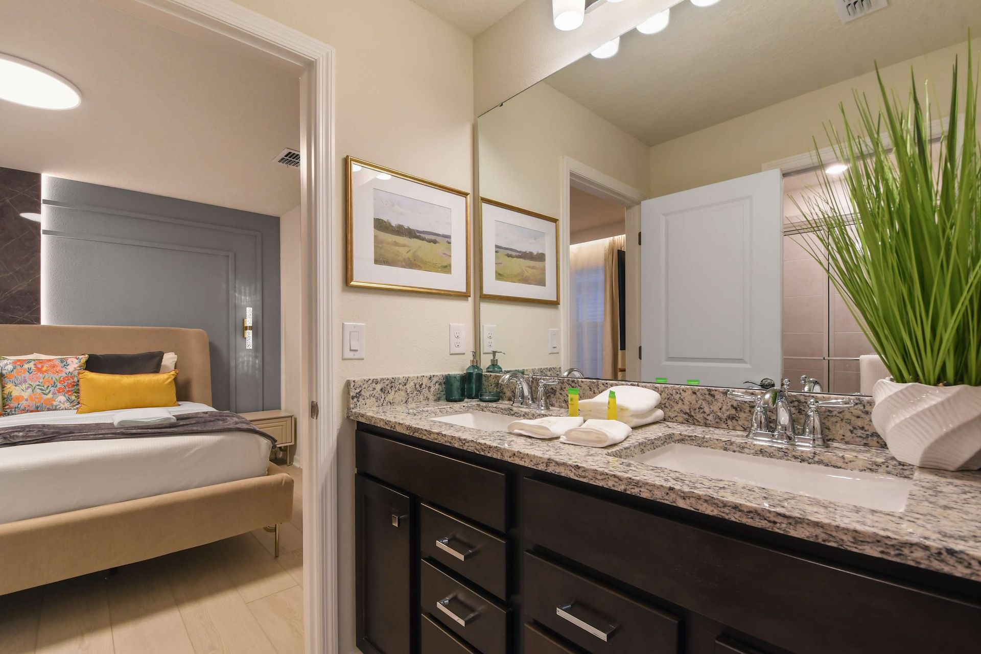 Bright bathroom with granite double vanity and walk-in shower.