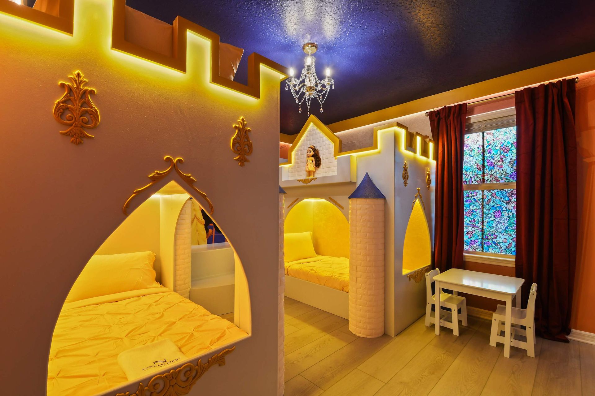 Magical castle-themed room with bunk beds, chandelier, and charm!