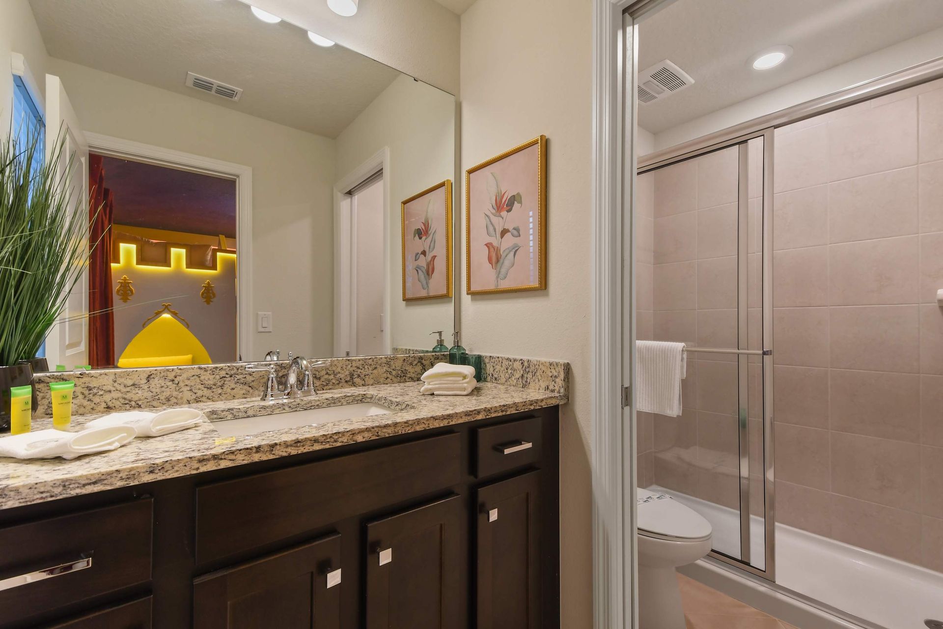 Modern bathroom with dual sinks, glass shower, and sleek design!