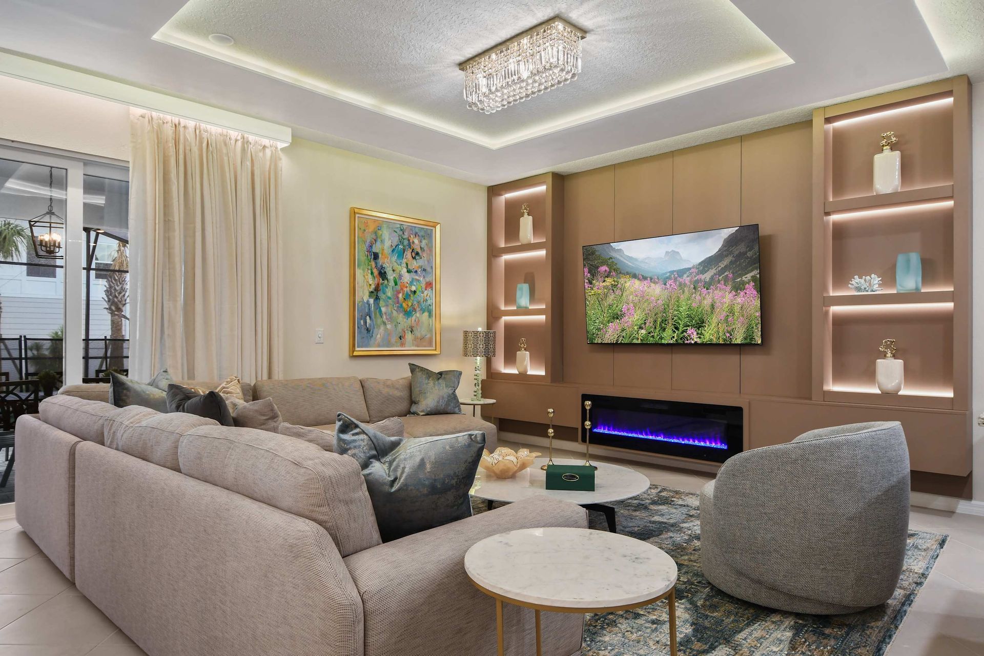 Relax in this spacious, stylish living room with plush sofas, modern decor, and a large Smart TV – perfect for gathering with family and friends.