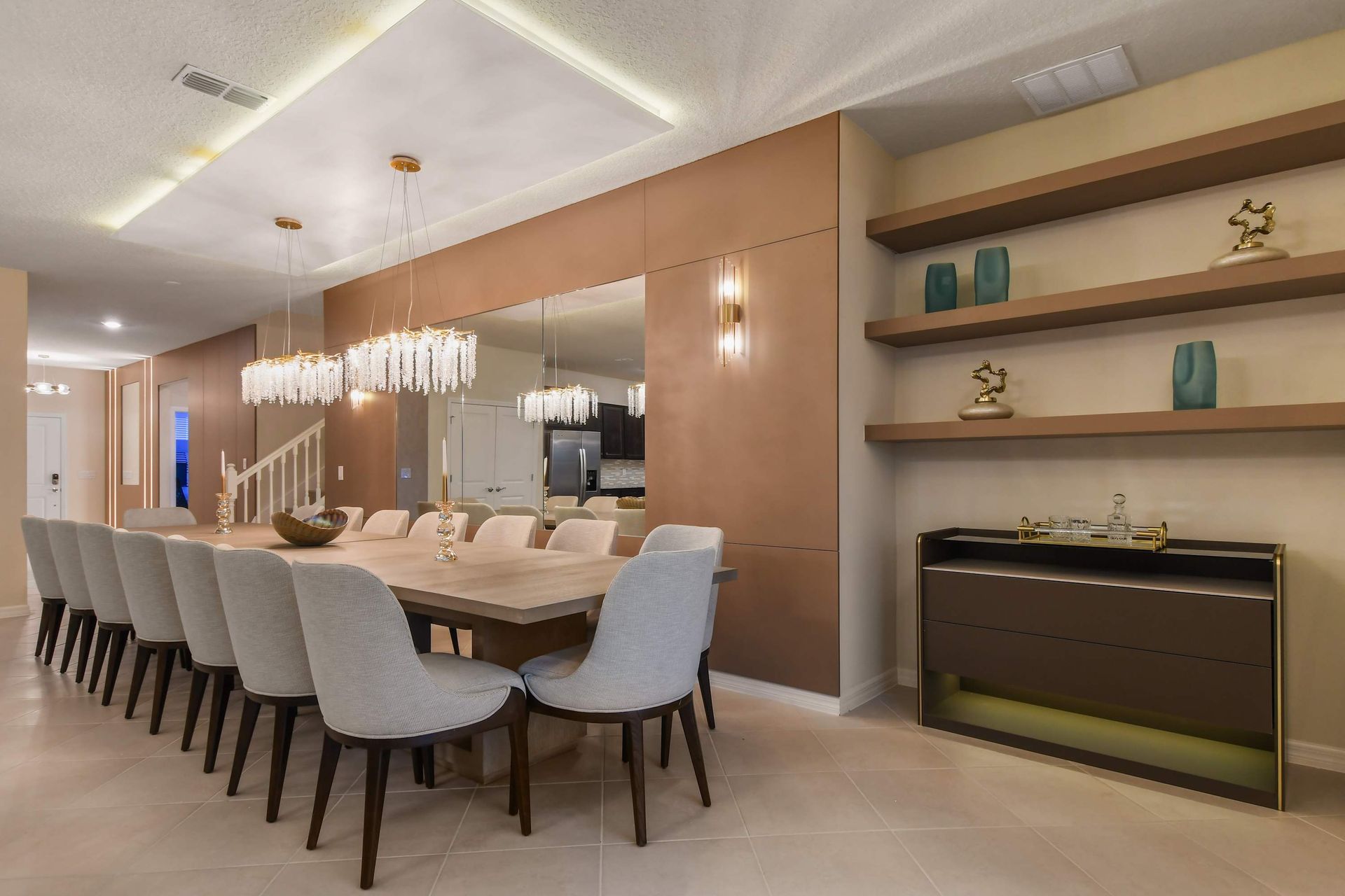 Luxury dining space with chic chandeliers and modern shelving.