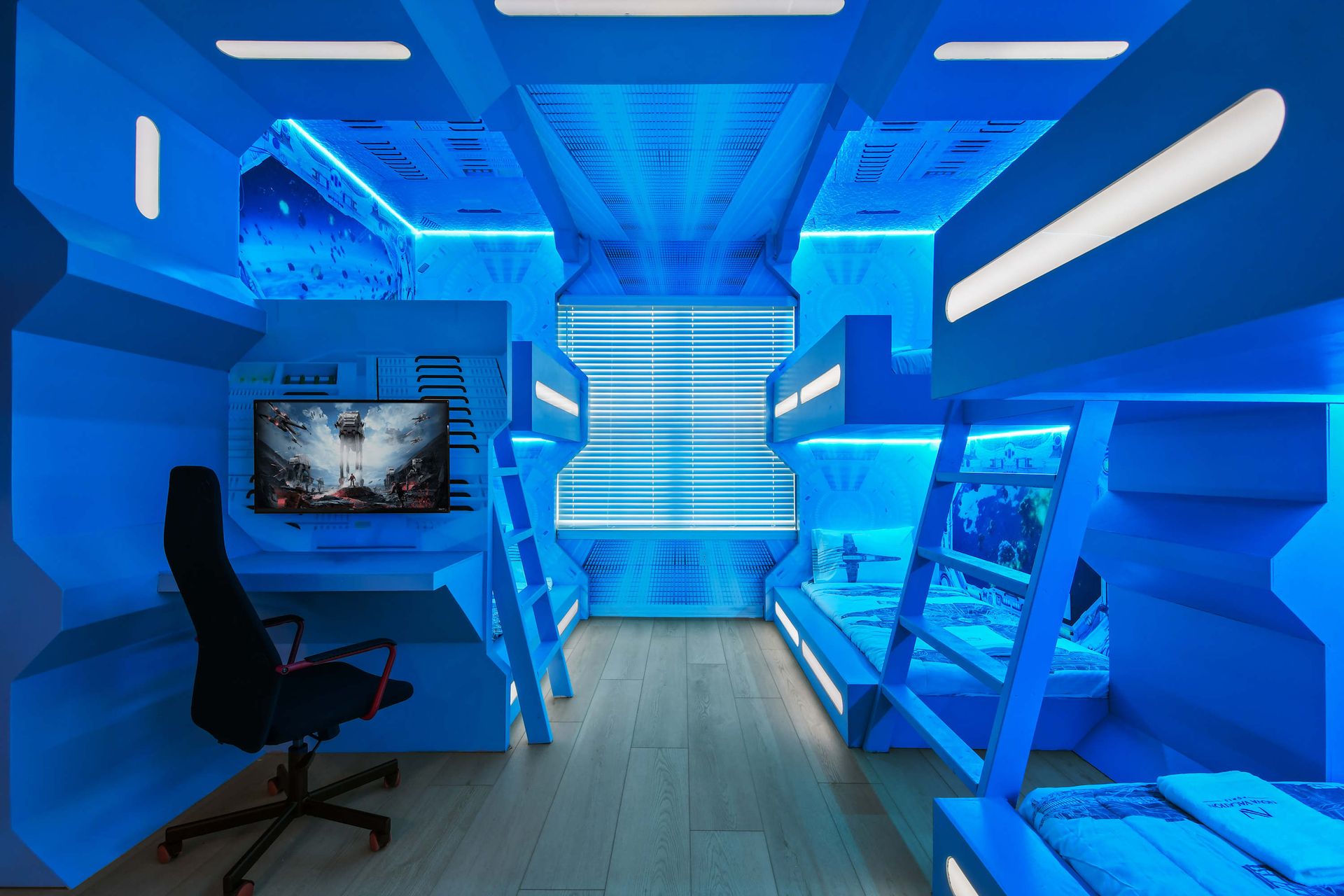 Futuristic space-themed bedroom with bunk beds and gaming setup.