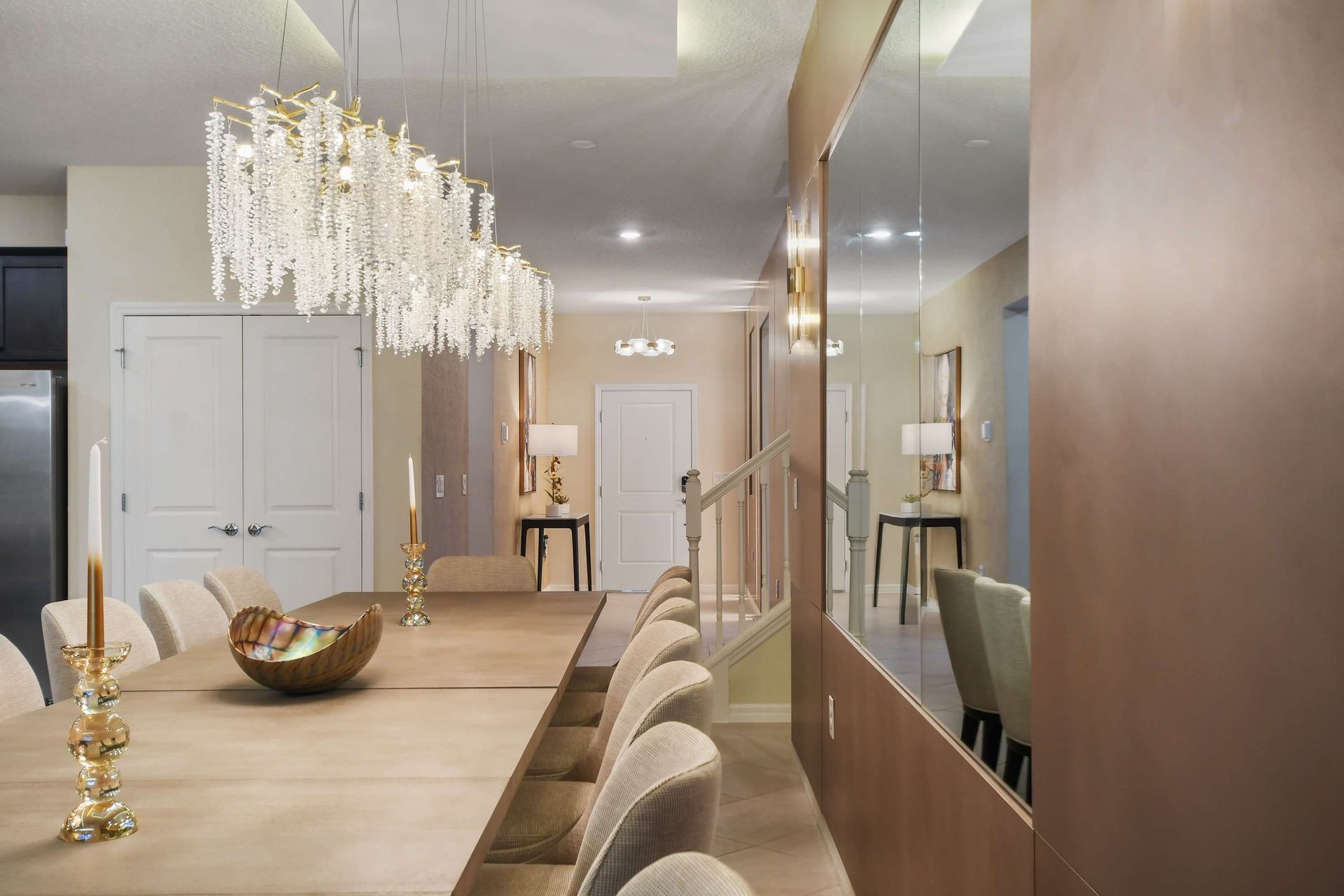 Elegant dining area with crystal chandeliers and mirrored accents.