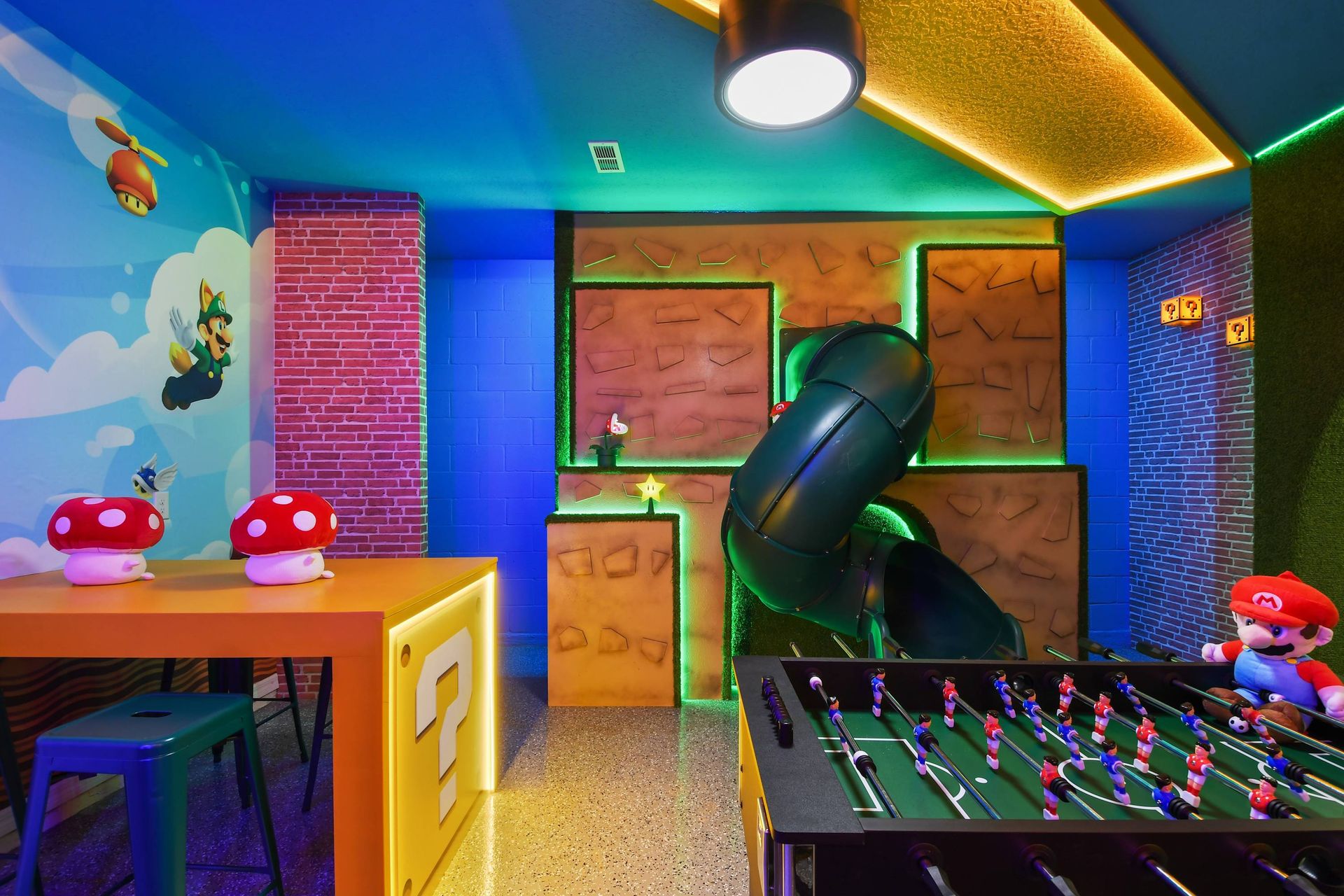 Whimsical Super Mario-themed room with slide, foosball, and fun!
