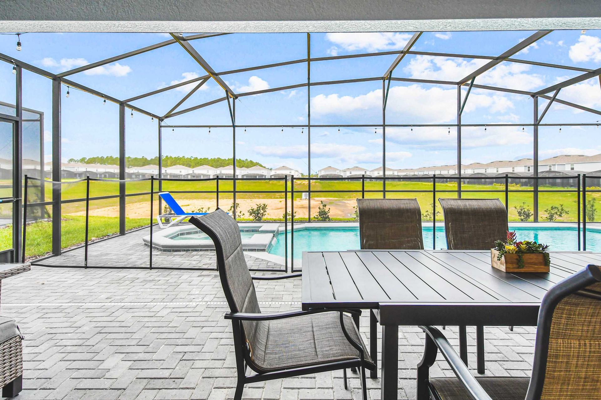 Relax by the screened-in pool with comfy loungers and serene outdoor dining space.