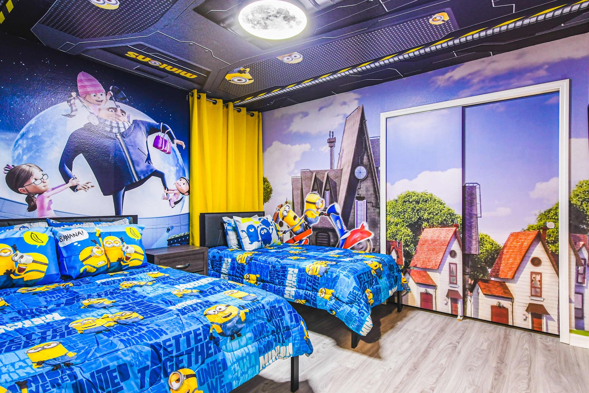 Fun-filled kids' room with vibrant Minion theme, twin beds, and immersive murals.