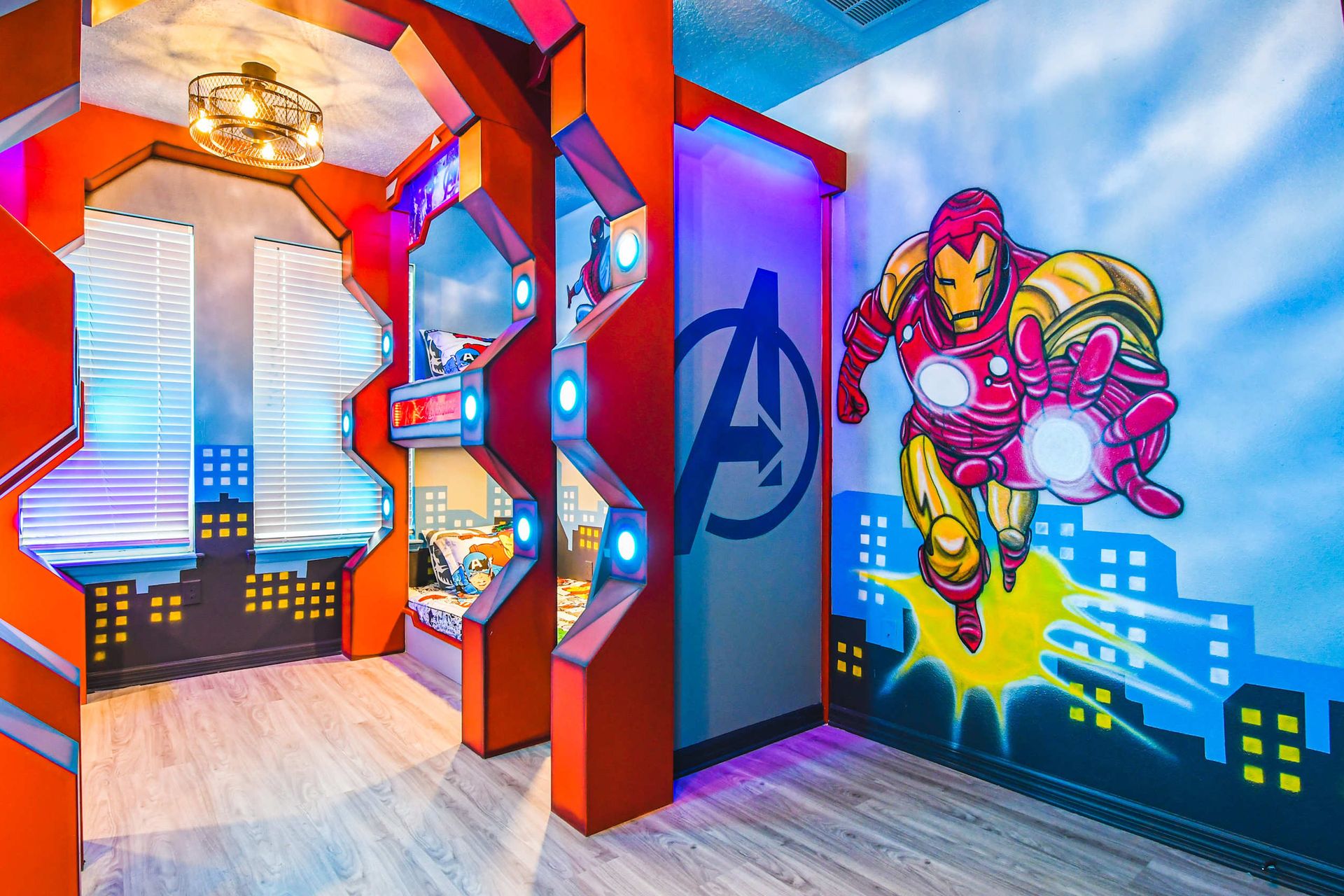 Avengers-themed bunk room with glowing lights, bold murals, and heroic city vibes.