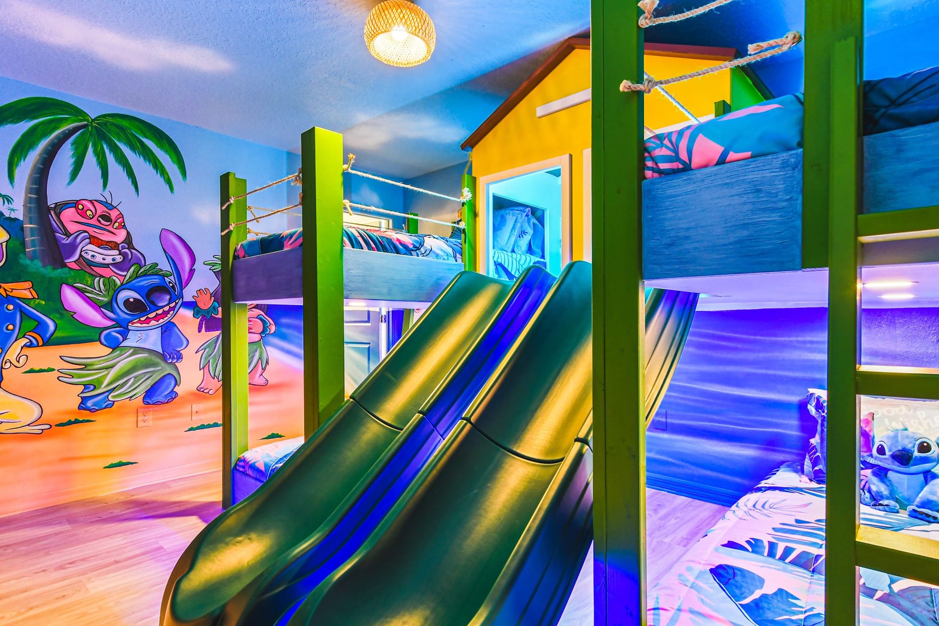 Vibrant modern bedroom with bold teal and gold accents, king bed, and luxe lighting.