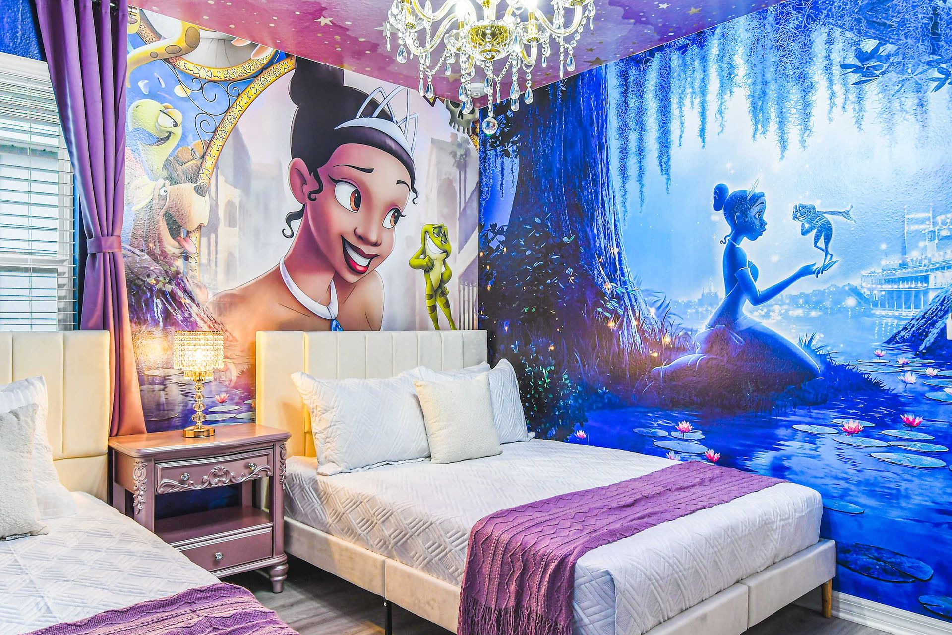 Magical princess room with dreamy murals, elegant beds, and a sparkling chandelier.