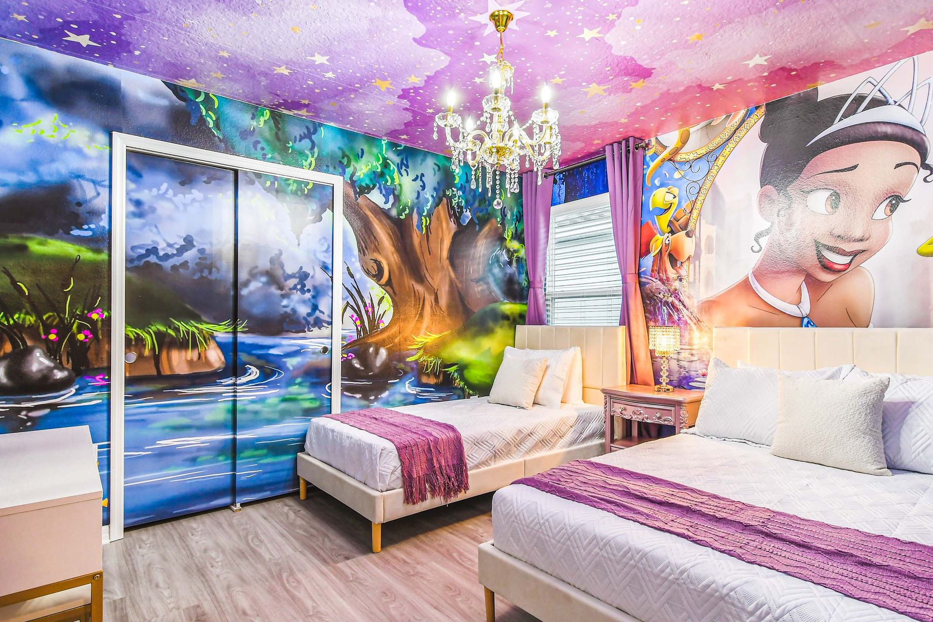 Enchanting princess-themed bedroom with dreamy murals, chandelier, and cozy twin beds.