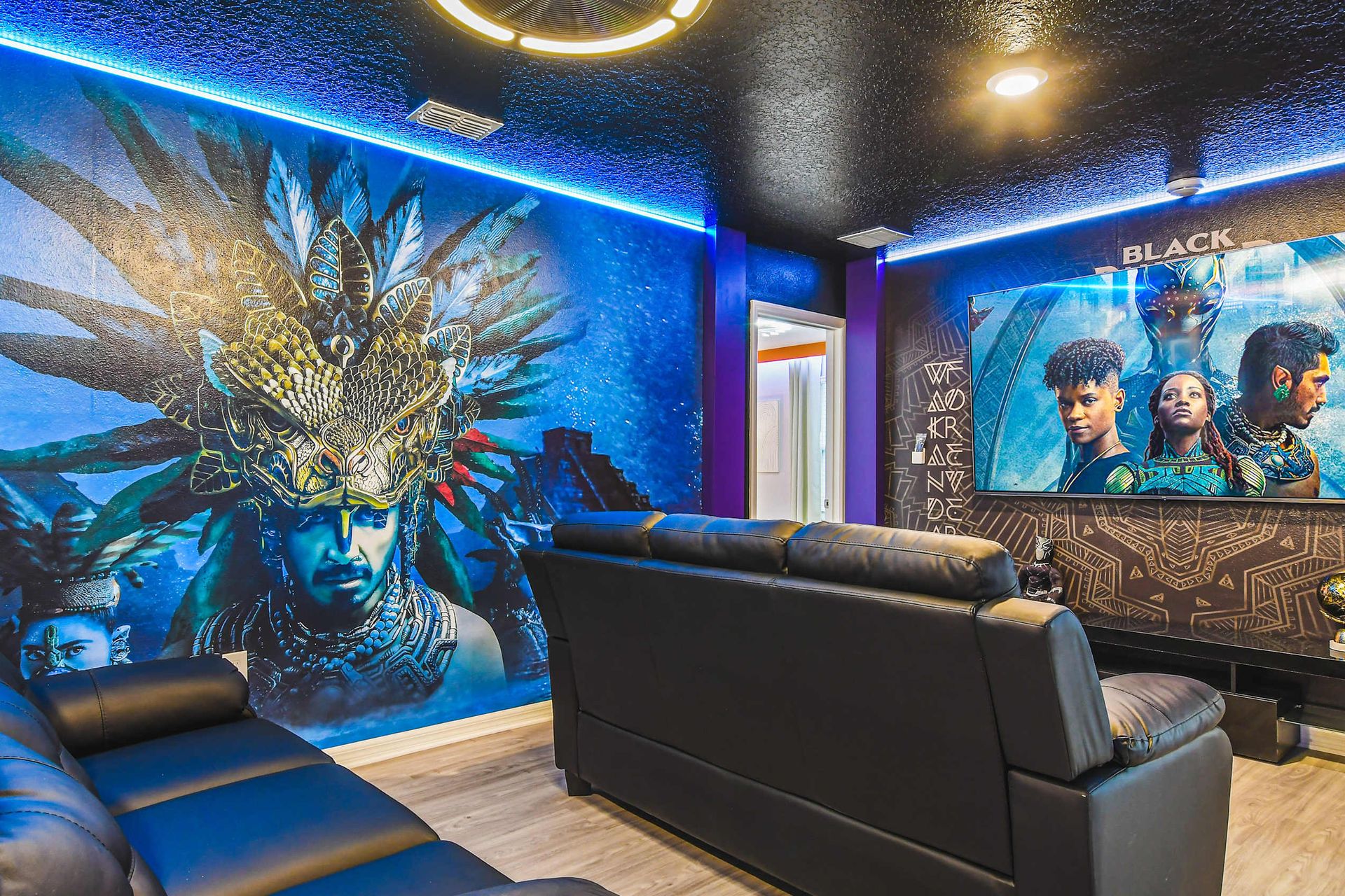 Immersive movie room with bold murals, leather seating, and epic superhero style.