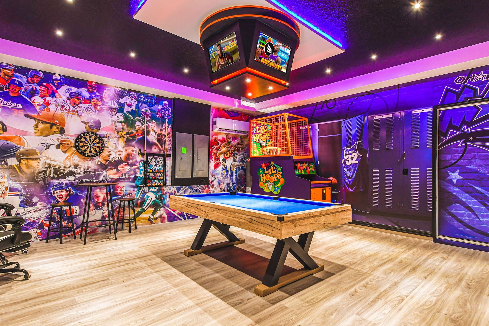 Ultimate sports-themed game room with pool, arcade hoops, dartboard, and murals.