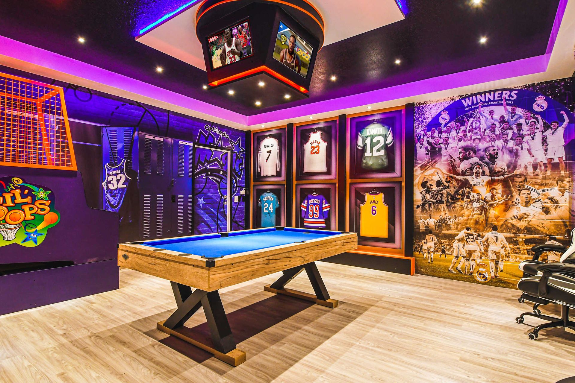 Epic game room with framed jerseys, arcade hoops, pool table, and champion vibes.
