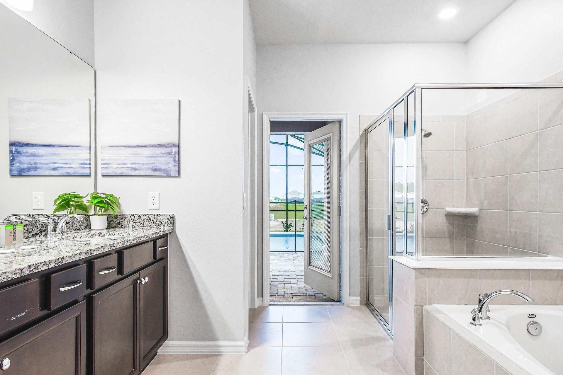 Spa-style ensuite with soaking tub, walk-in shower, and direct pool access..