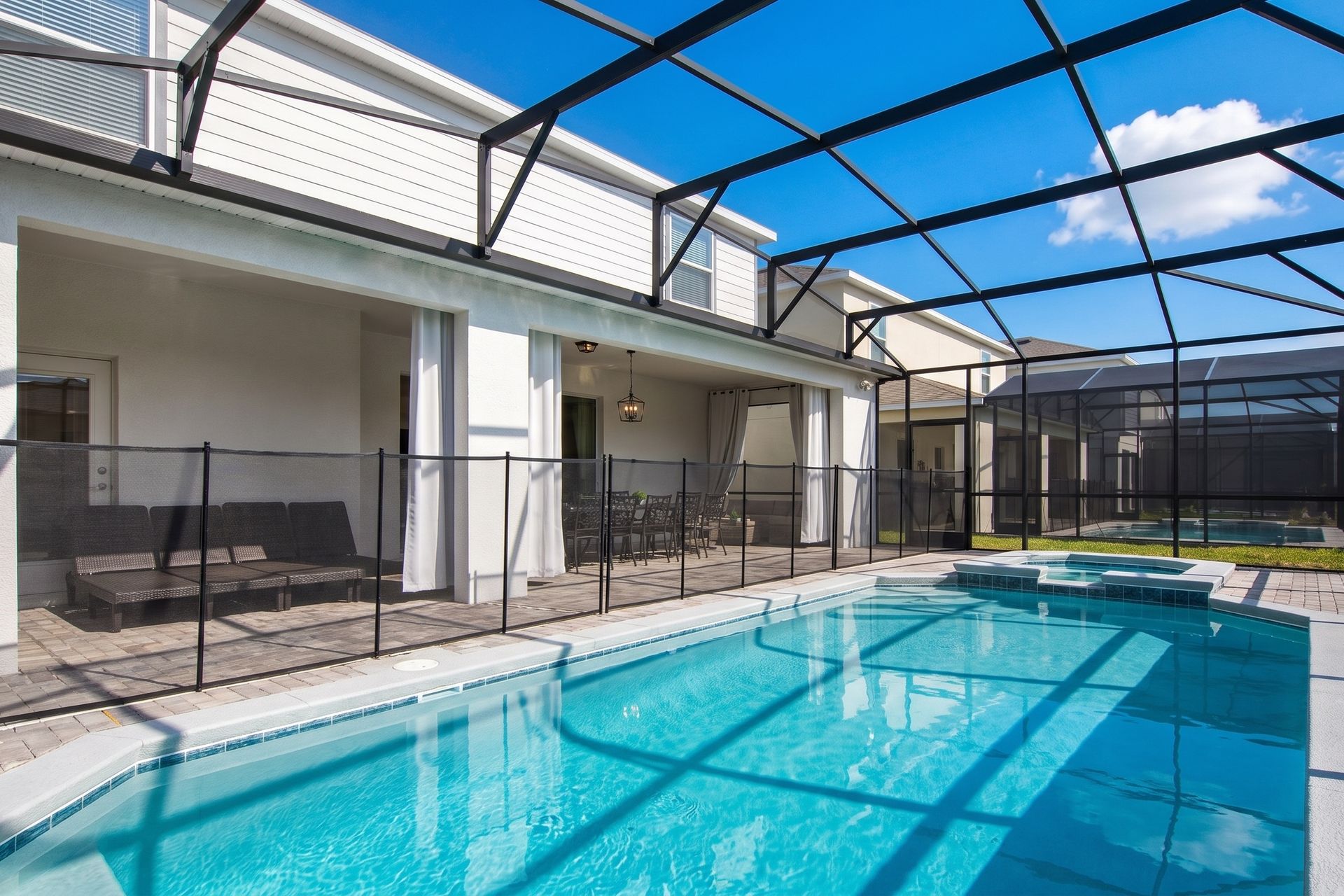 Spacious screened pool area with lounge seating for relaxing day or night.