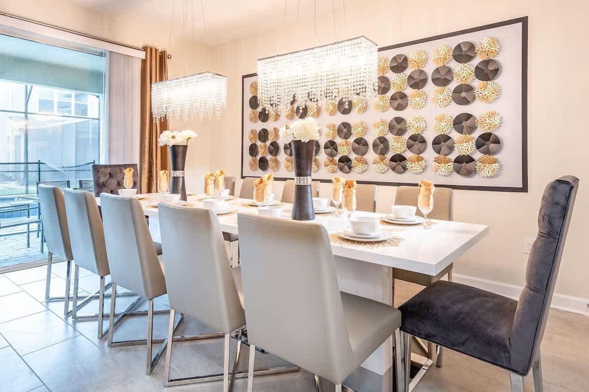 Elegant dining room with seating for 12, crystal lighting, and modern decor!