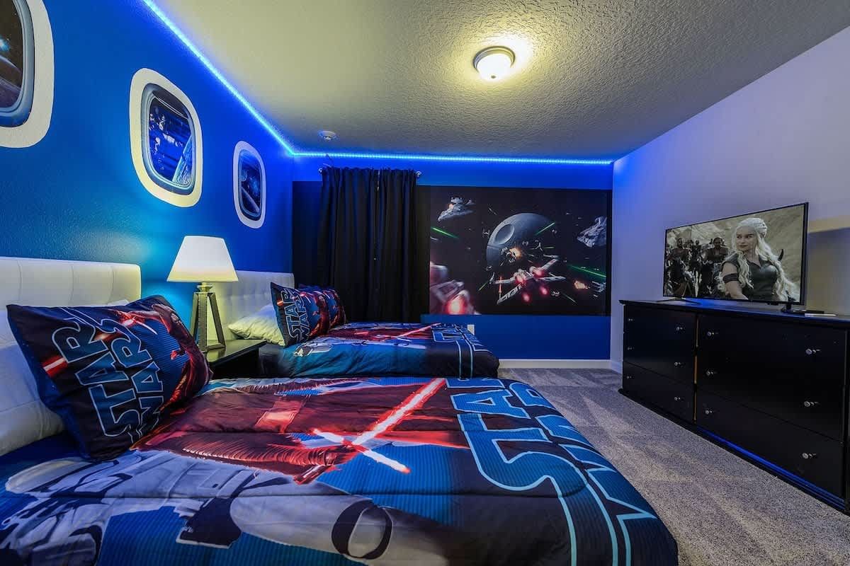 Epic space-themed room with twin beds, LED lights, and a galaxy wall mural!