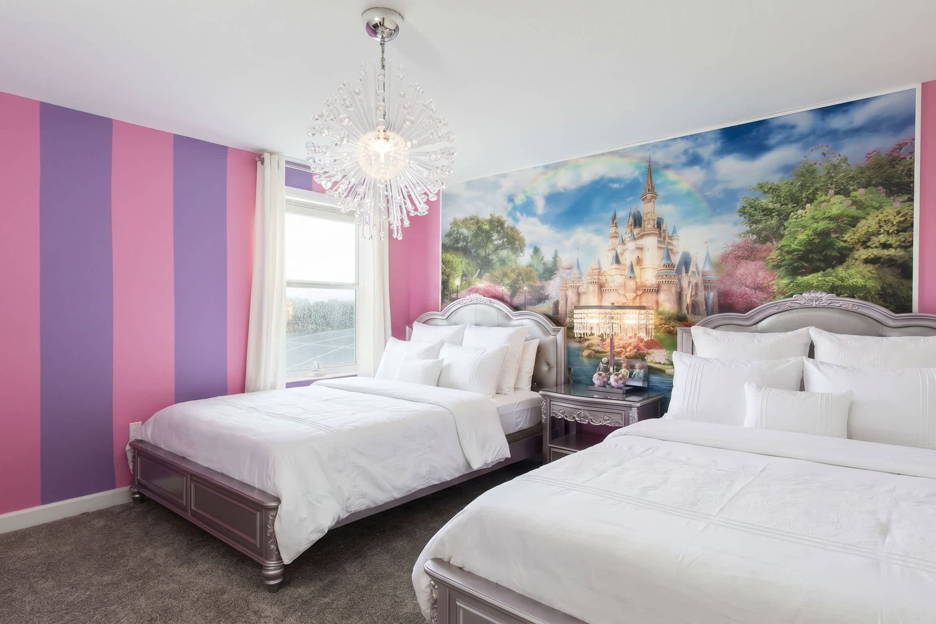 Magical princess room with vibrant colors, sparkling chandelier, and twin beds.