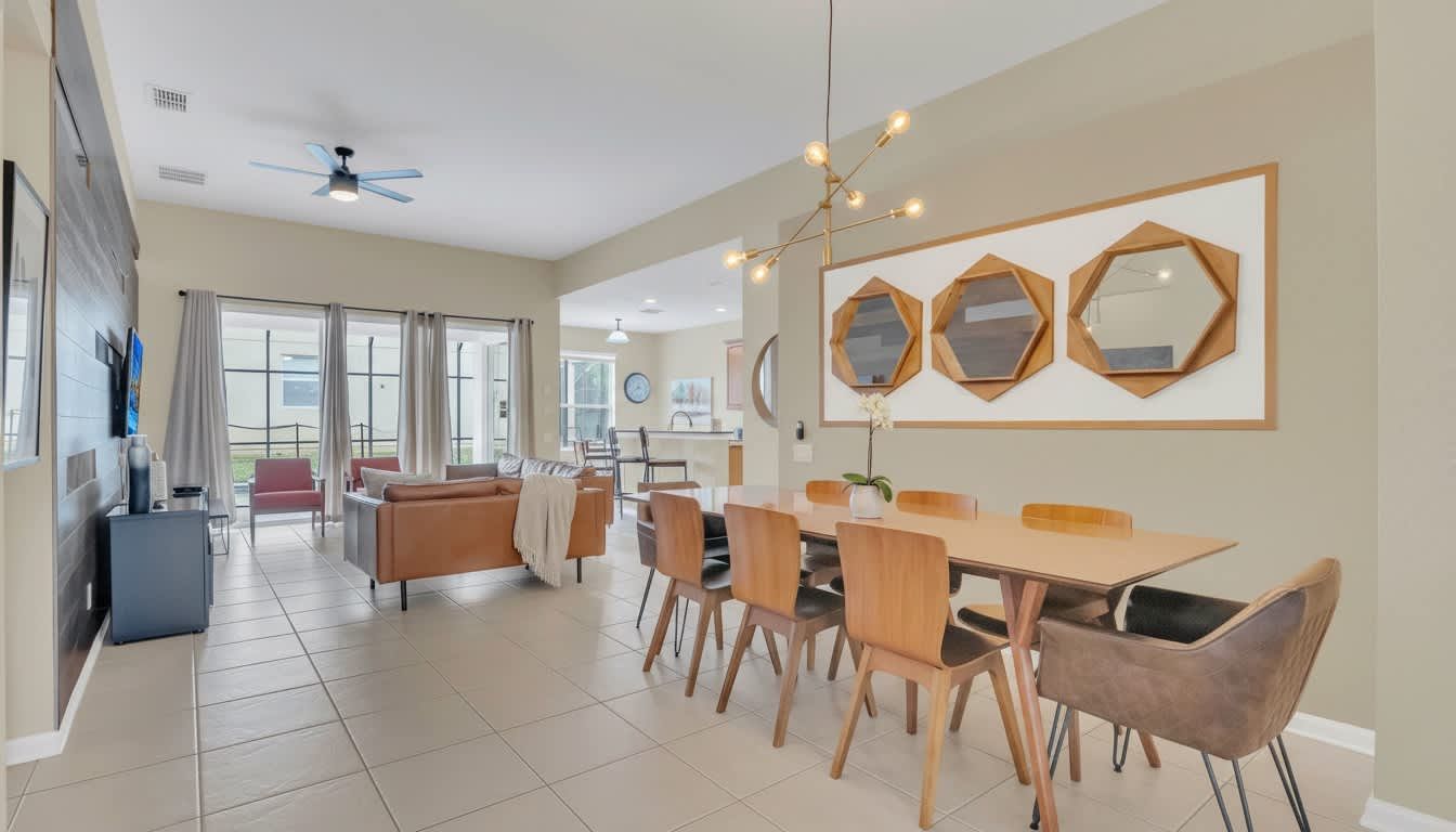 Sophisticated open-plan dining area featuring modern gold accents and warm, contemporary design.