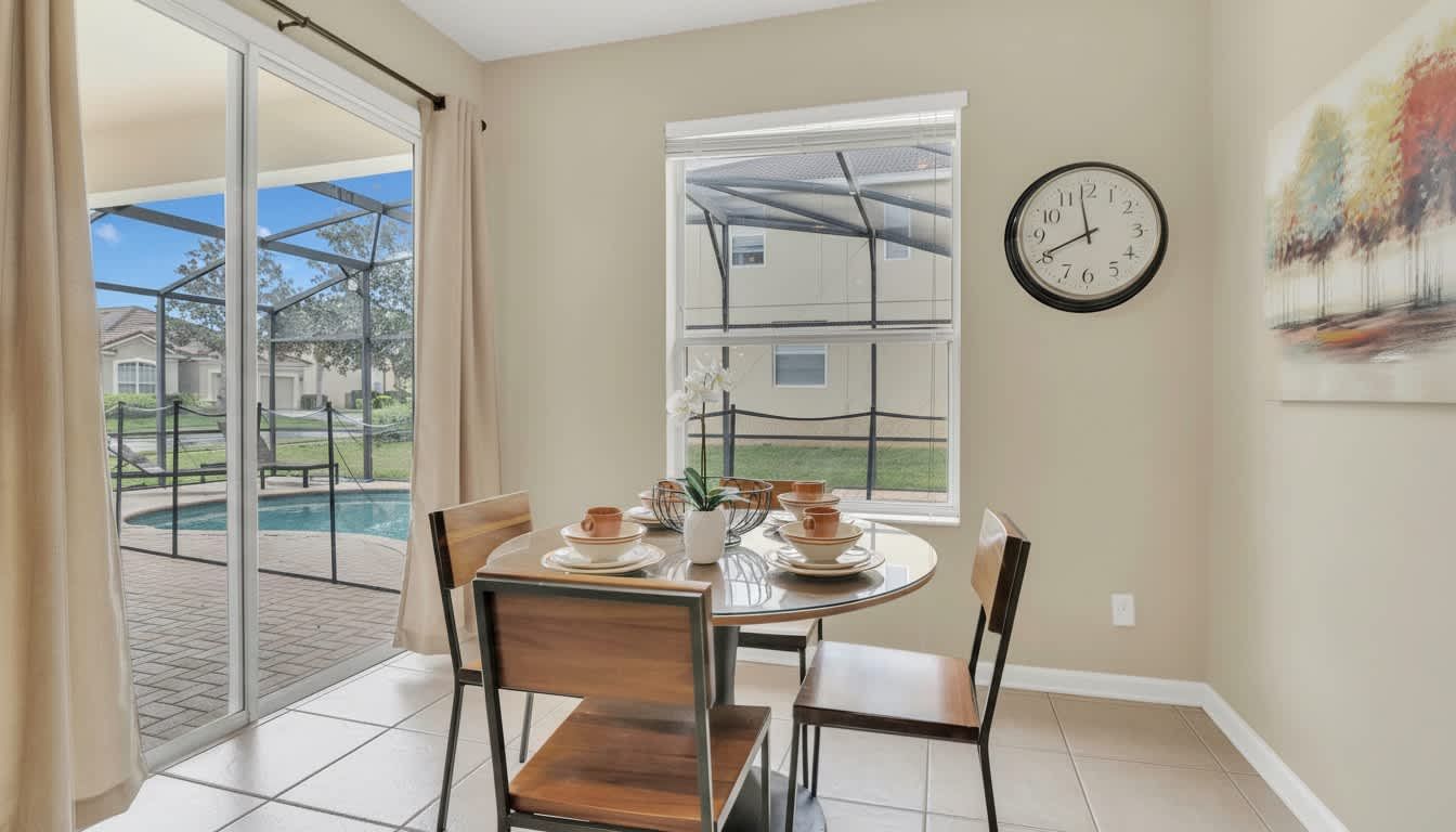 Morning light bathes a modern dining nook overlooking a serene private poolside oasis.