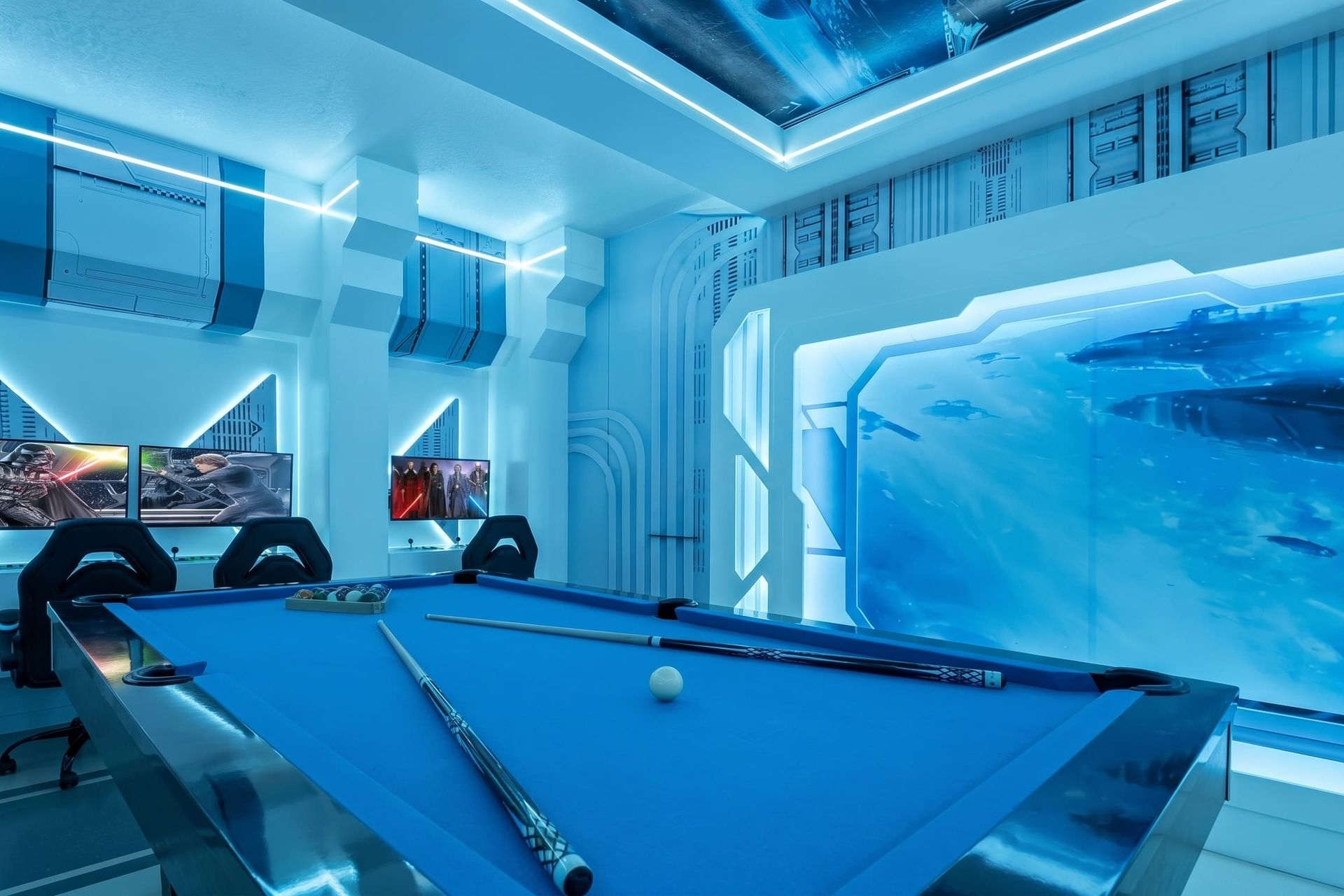 Electric blue light, pool table, and ultimate gaming setup.
