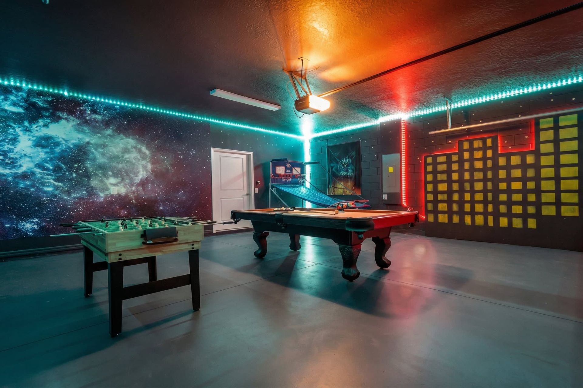 Game room featuring both foosball and pool tables