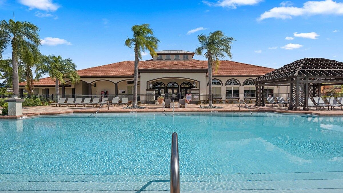 Luxurious poolside retreat with cabanas, loungers, and palm views!