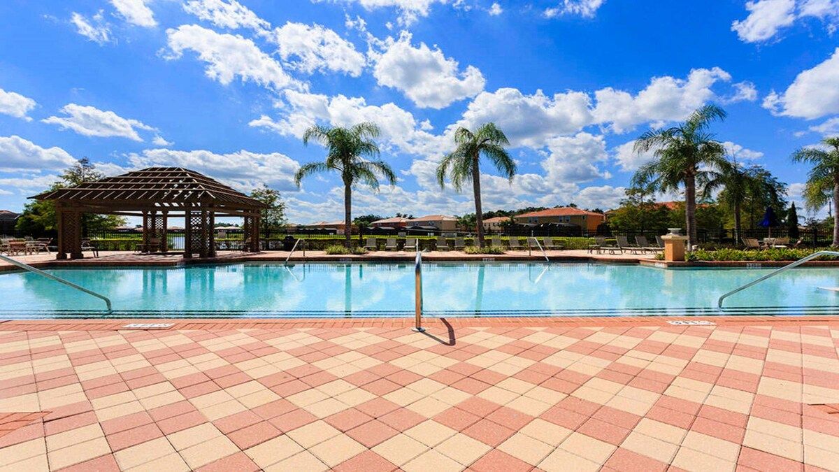 Sparkling pool with palm views and a serene lakeside backdrop!