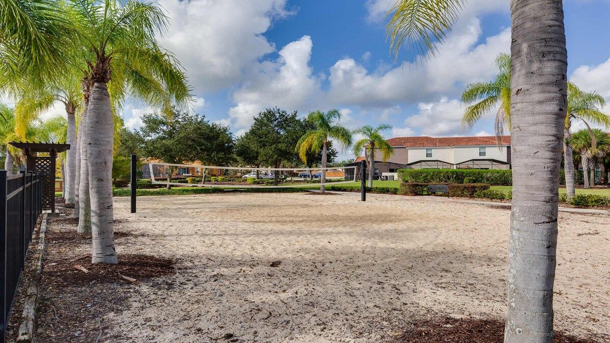 Relax & play! Palm-lined sand volleyball court in sunny paradise.