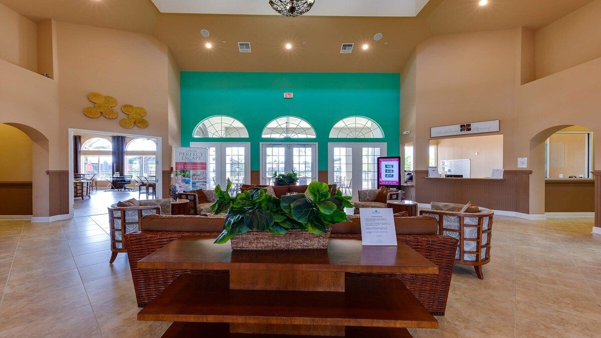 Stylish clubhouse with cozy seating and vibrant tropical decor!