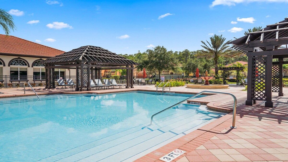 Luxurious poolside retreat with cabanas, loungers, and palm views!