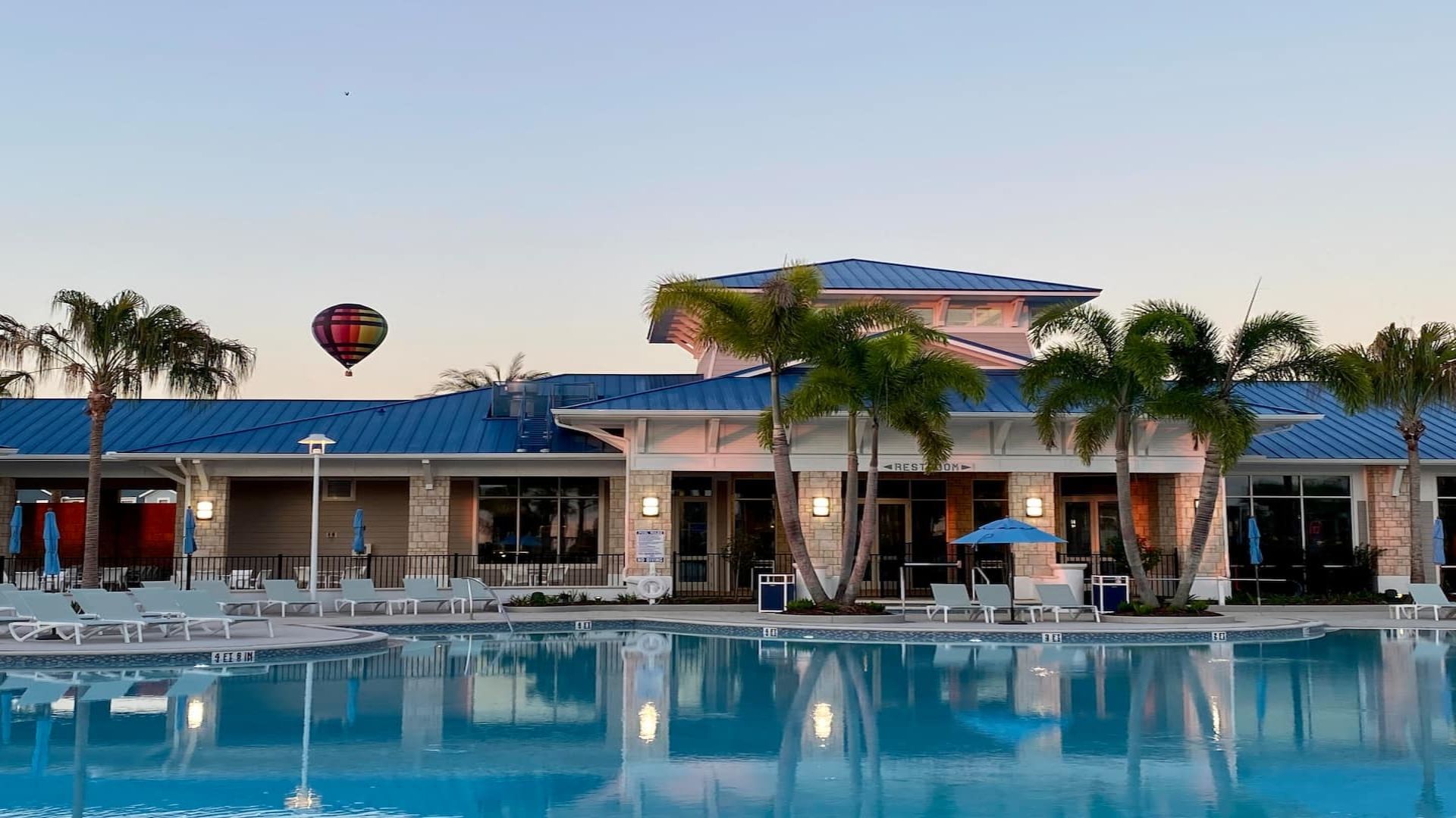 Resort Pool: Tropical oasis surrounded by palm trees.