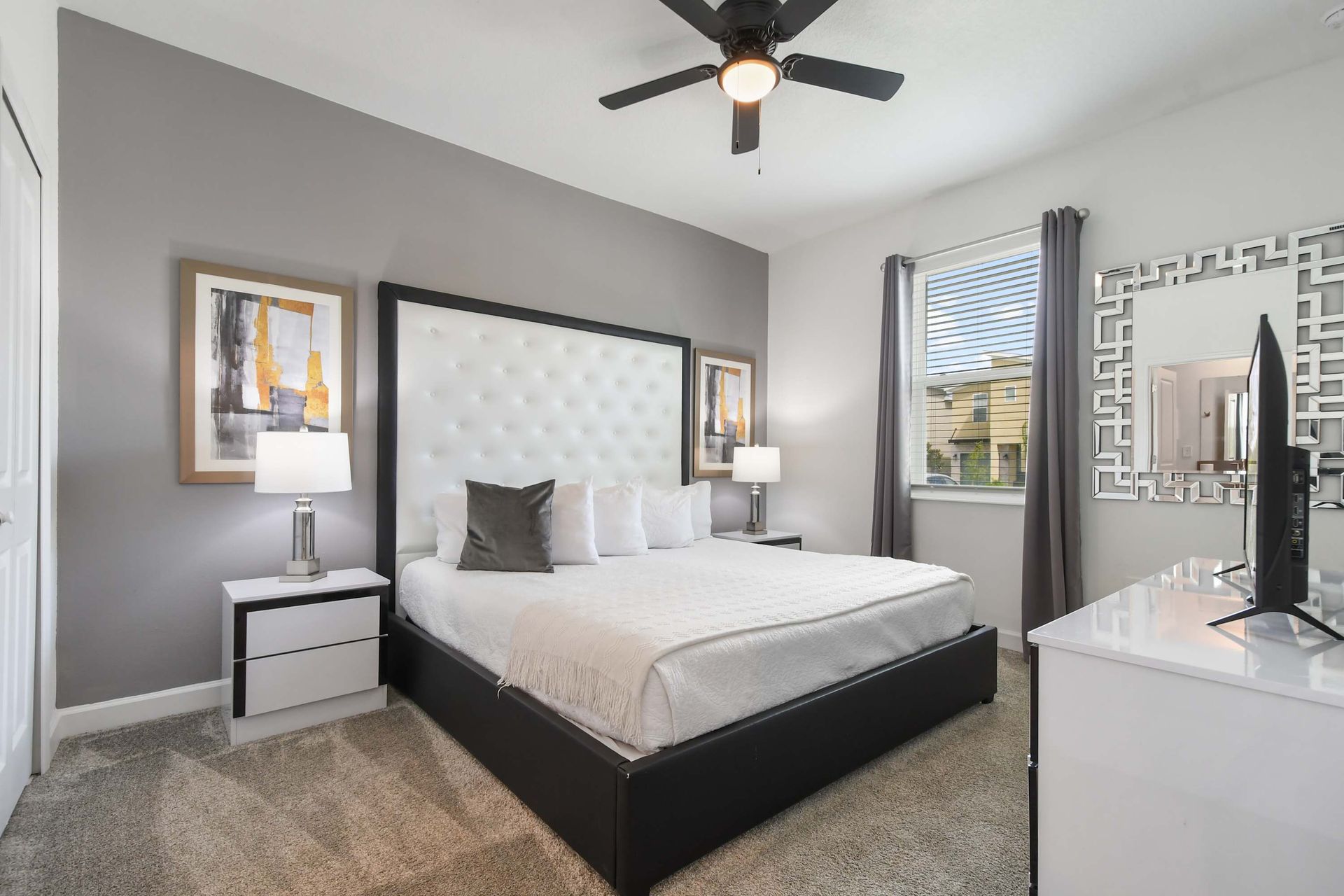 Stylish bedroom retreat with king bed, plush carpet, and modern decor touches.

