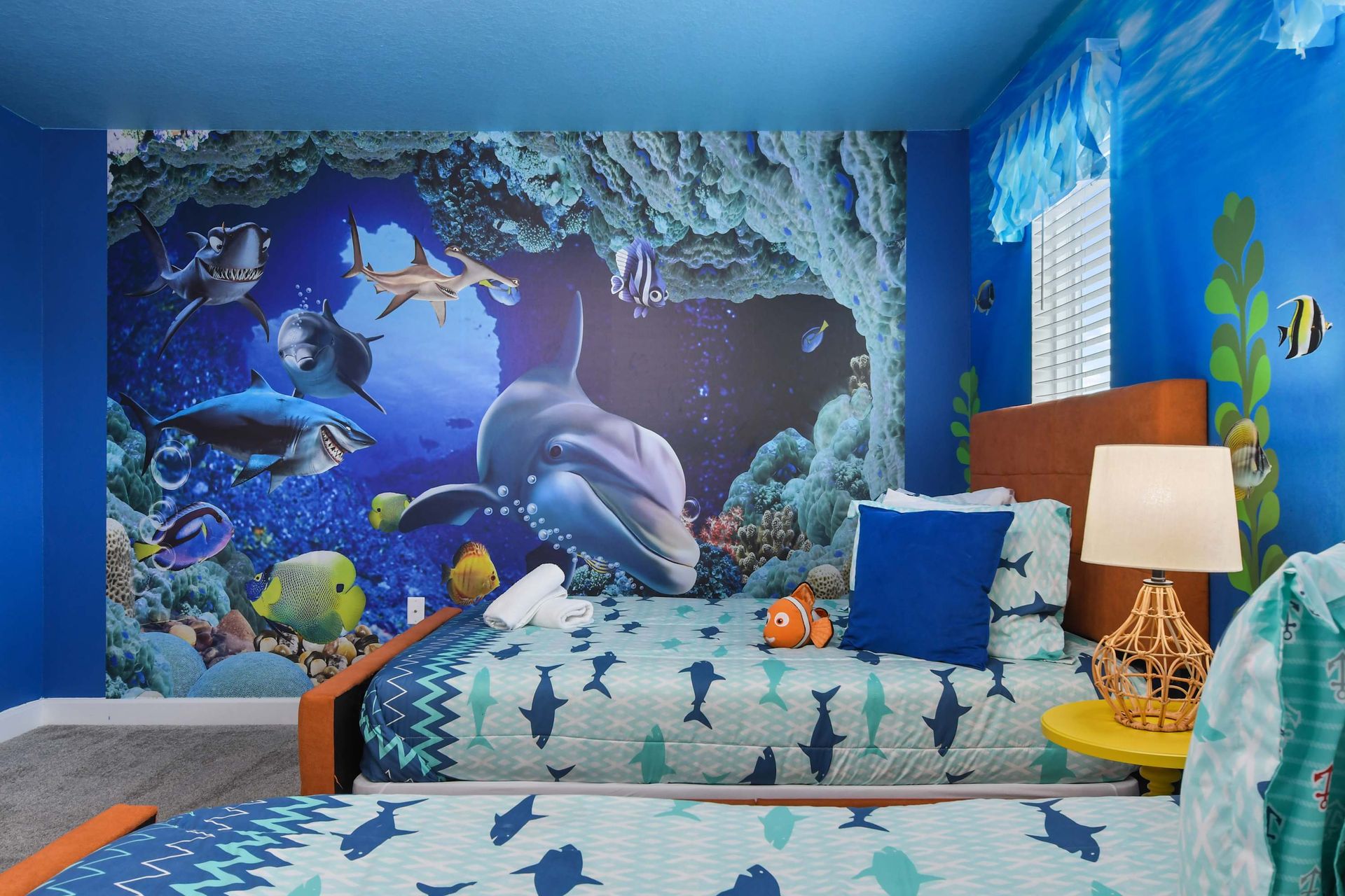 Spacious loft with galaxy wall art, cozy sectional, and a sleek entertainment setup.
