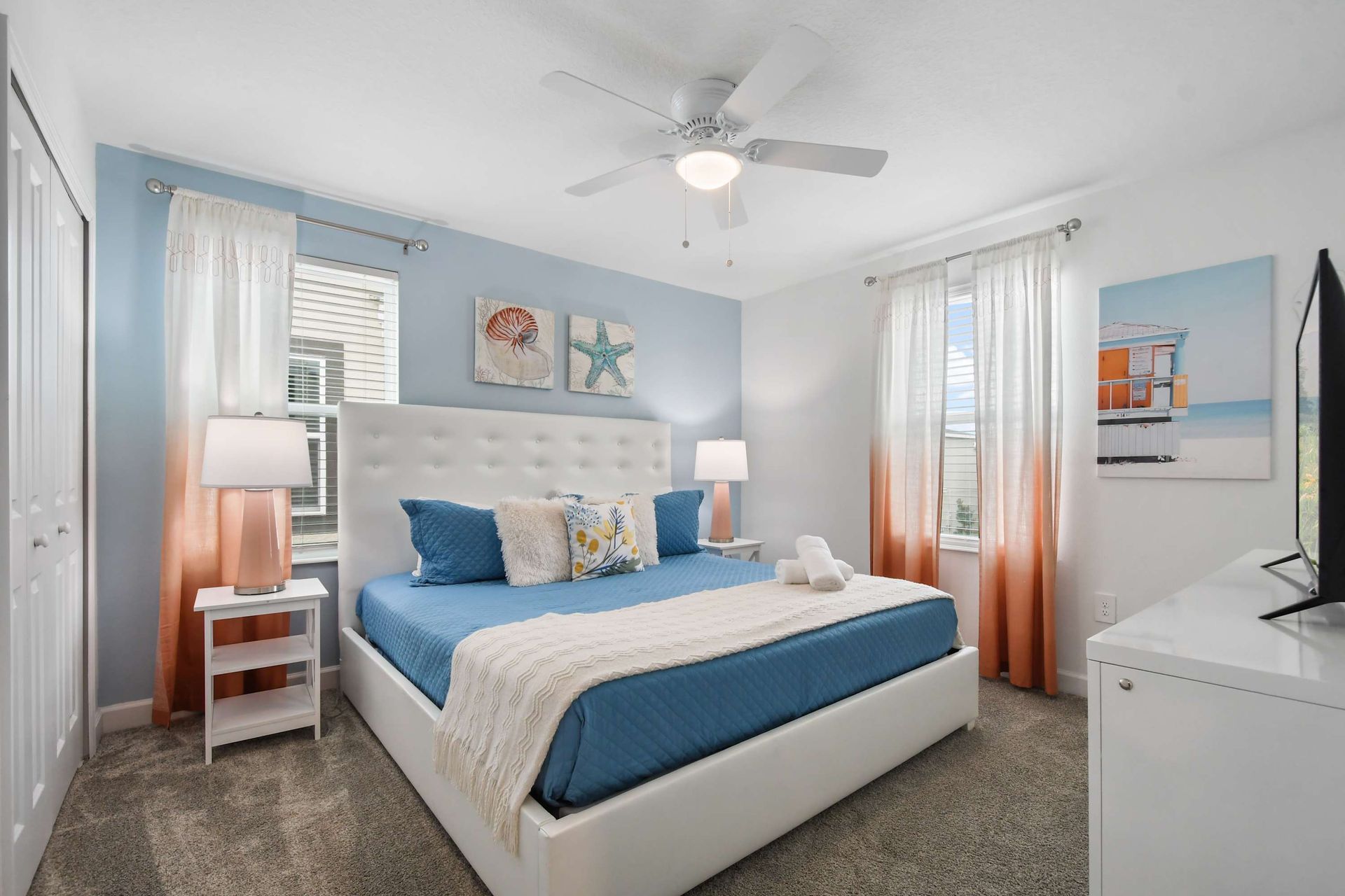 Coastal-inspired bedroom with king bed, soft tones, and plenty of natural light.
