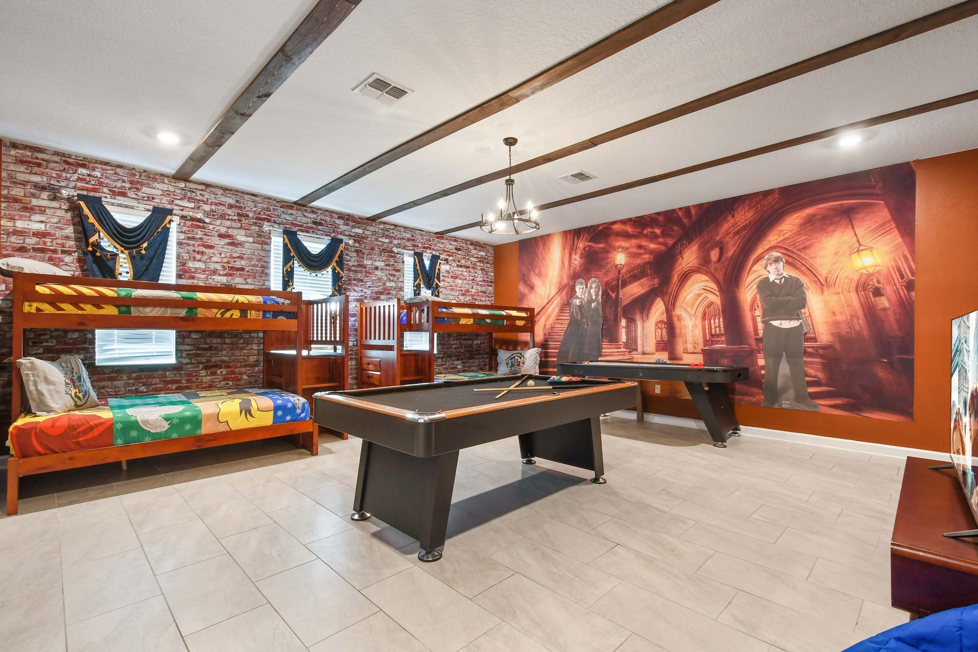 Themed game room with bunk beds, pool table, and immersive wall mural fun.
