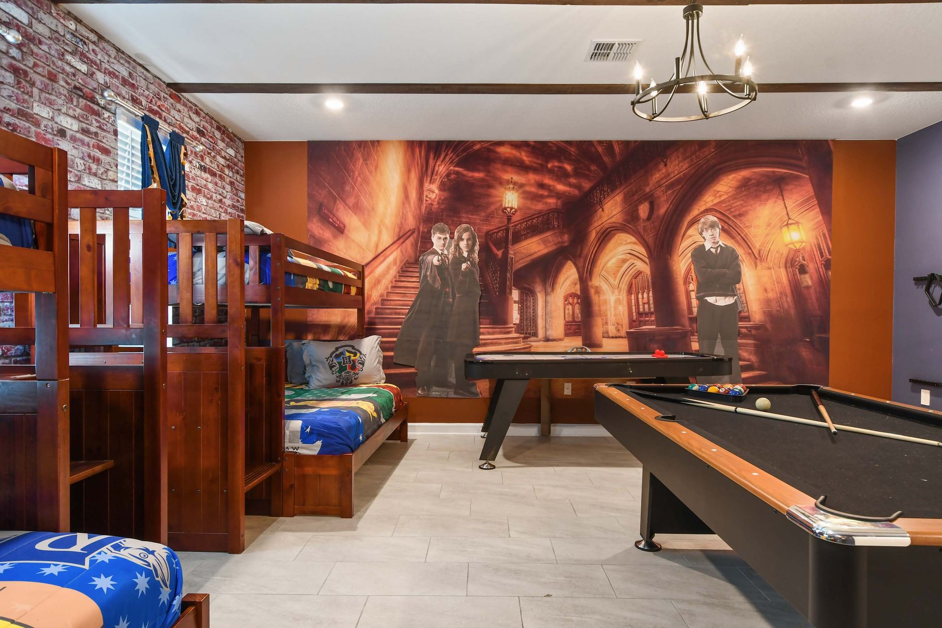 Magical-themed game room with bunk beds, pool table, and enchanting wall art.
