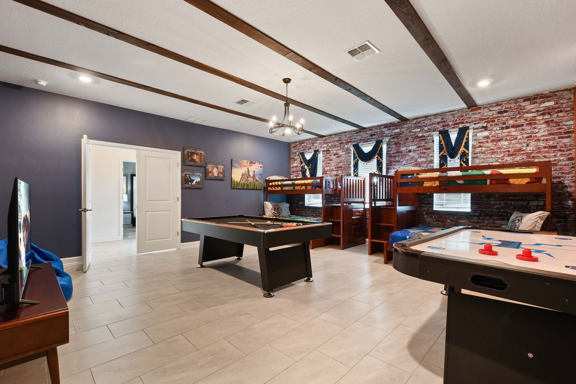Epic game room with bunk beds, pool, air hockey, and wizard-themed accents.
