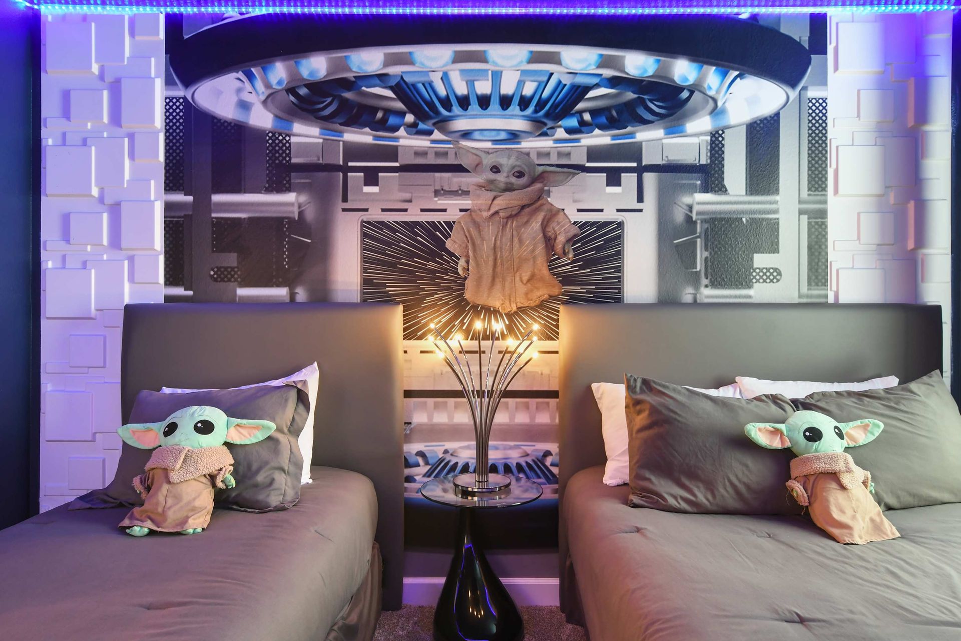 Galactic-themed kids’ room with twin beds, LED lights, and space adventure decor.
