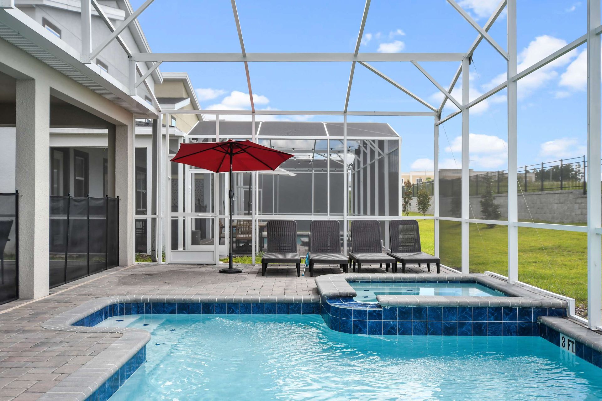 Private screened-in pool and spa with lounge chairs and sunny outdoor vibes.
