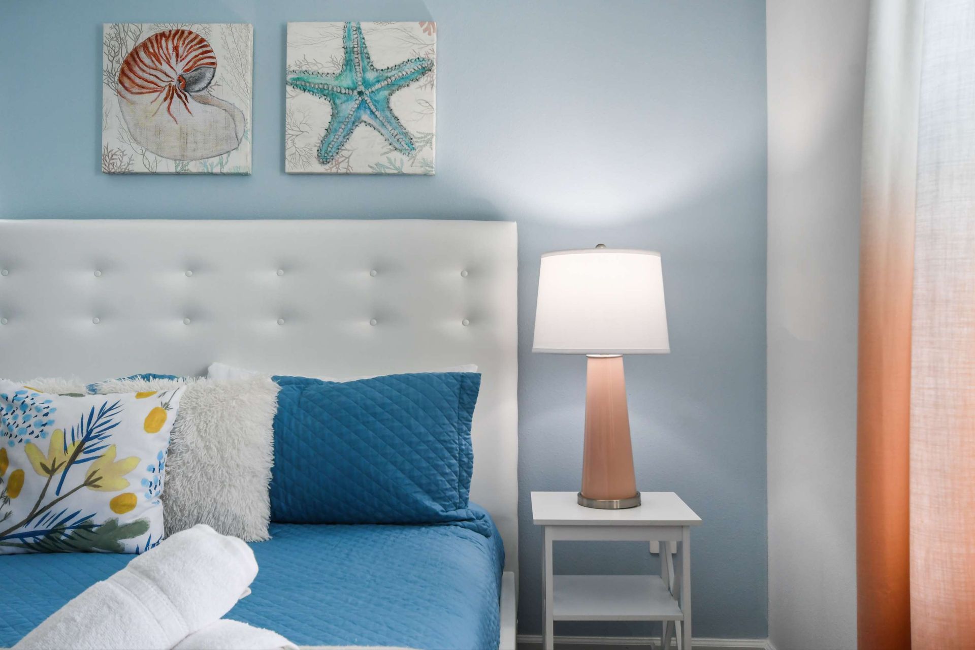 Coastal-inspired bedroom with king bed, soft tones, and plenty of natural light.
