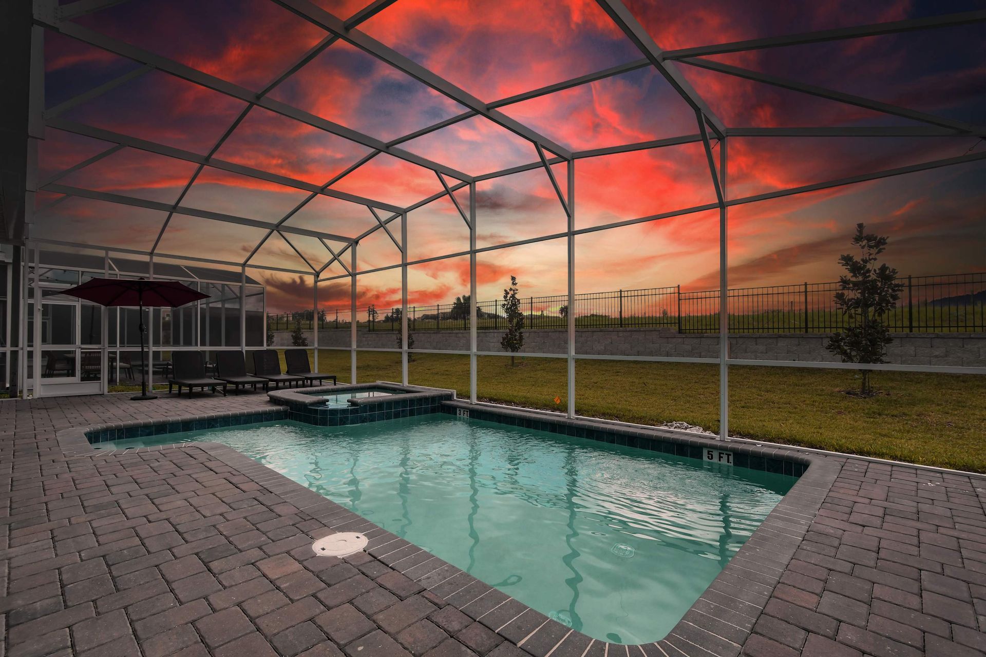 Screened-in pool and spa with sunset views—perfect for relaxing evenings.
